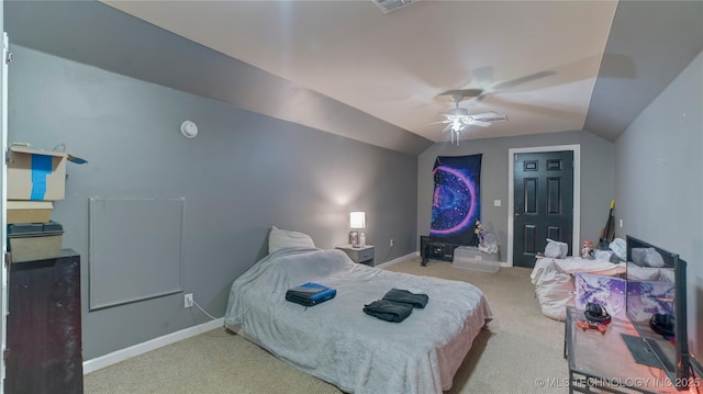 carpeted bedroom with ceiling fan and vaulted ceiling