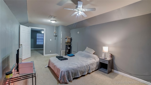 bedroom with vaulted ceiling, light colored carpet, and ceiling fan