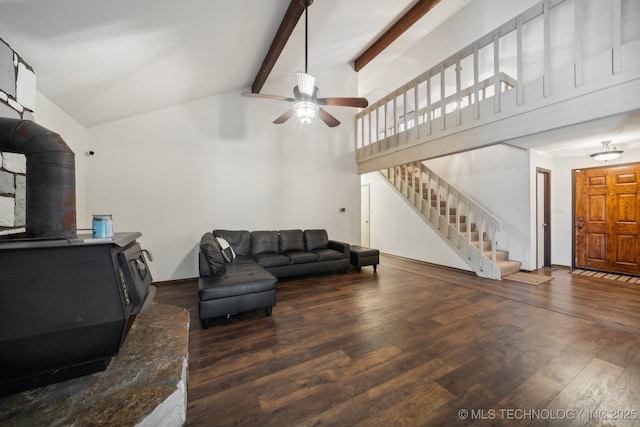 living room with high vaulted ceiling, a wood stove, dark hardwood / wood-style floors, ceiling fan, and beam ceiling