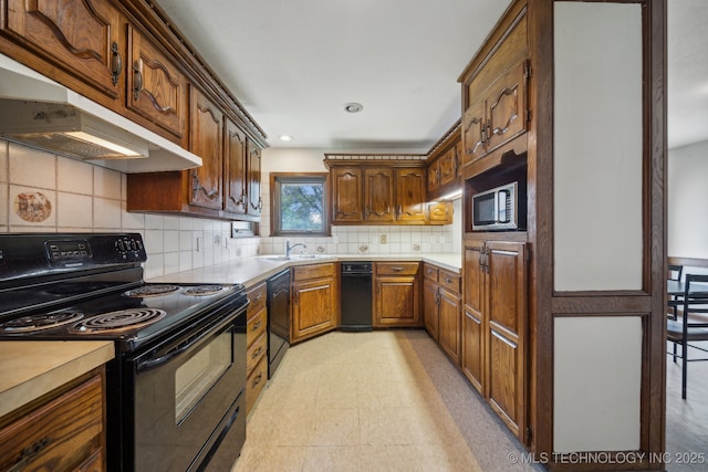 kitchen featuring tasteful backsplash, sink, and black appliances