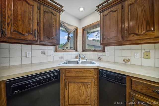 kitchen with tasteful backsplash, sink, and black dishwasher