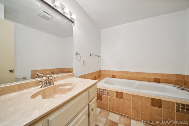 bathroom with a relaxing tiled tub, vanity, and toilet