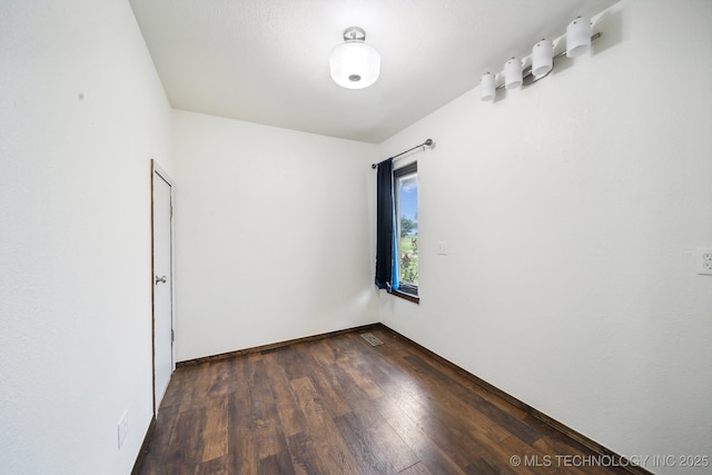 unfurnished room with dark hardwood / wood-style floors