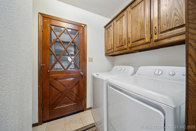 clothes washing area with cabinets, light tile patterned flooring, and separate washer and dryer