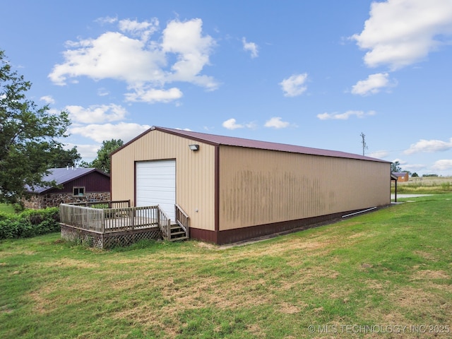 view of outbuilding featuring a garage and a lawn