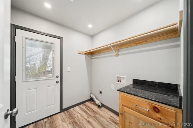 clothes washing area featuring hookup for a washing machine, electric dryer hookup, cabinets, and light hardwood / wood-style flooring