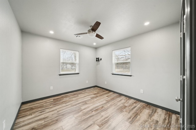 spare room featuring ceiling fan and light wood-type flooring