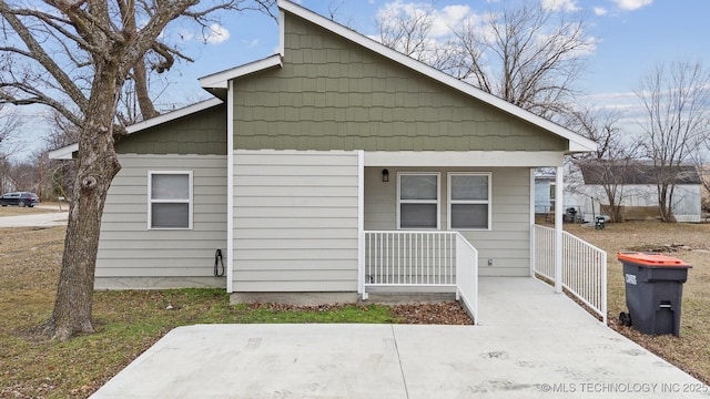 view of side of home with covered porch