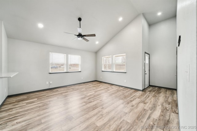 unfurnished living room with ceiling fan, high vaulted ceiling, and light hardwood / wood-style floors