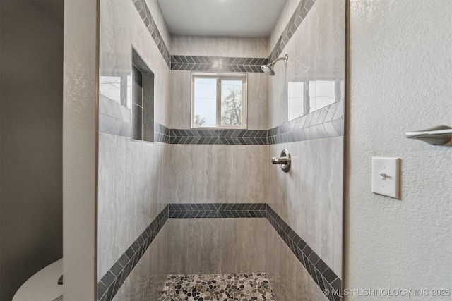 bathroom featuring tiled shower