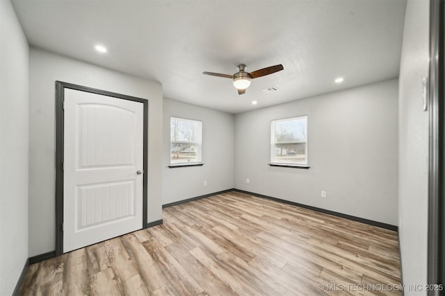 unfurnished bedroom with light hardwood / wood-style floors and ceiling fan