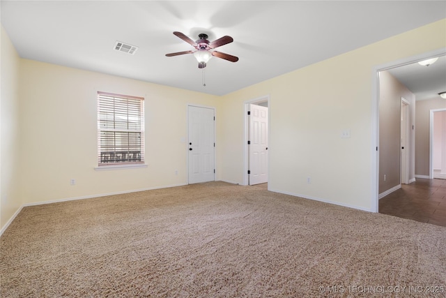 carpeted empty room featuring ceiling fan