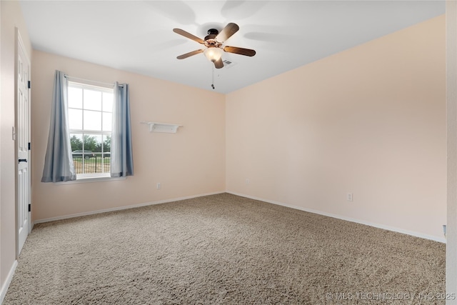 carpeted spare room featuring ceiling fan