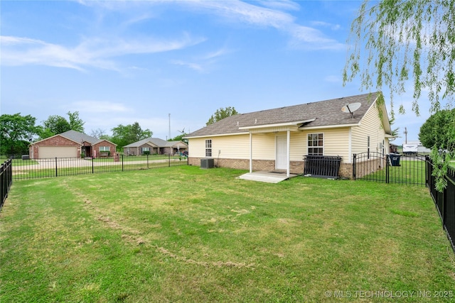 back of house with a lawn and central air condition unit