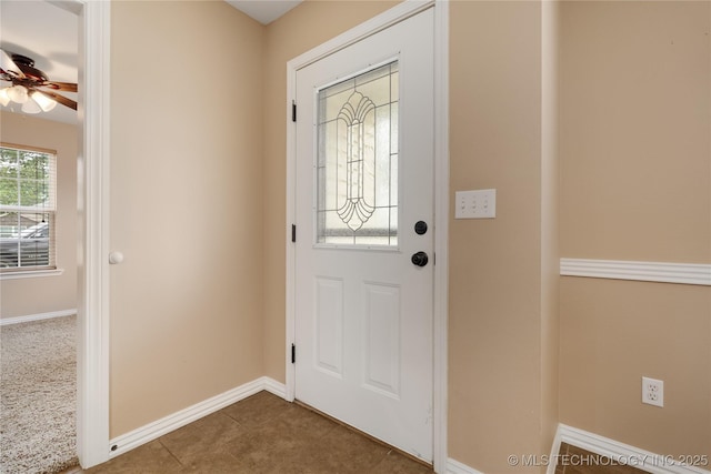 foyer entrance with tile patterned floors and ceiling fan