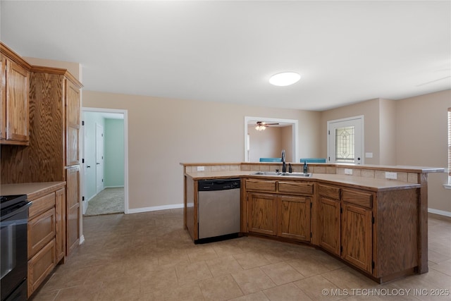 kitchen featuring sink, stainless steel dishwasher, an island with sink, black range with electric cooktop, and ceiling fan