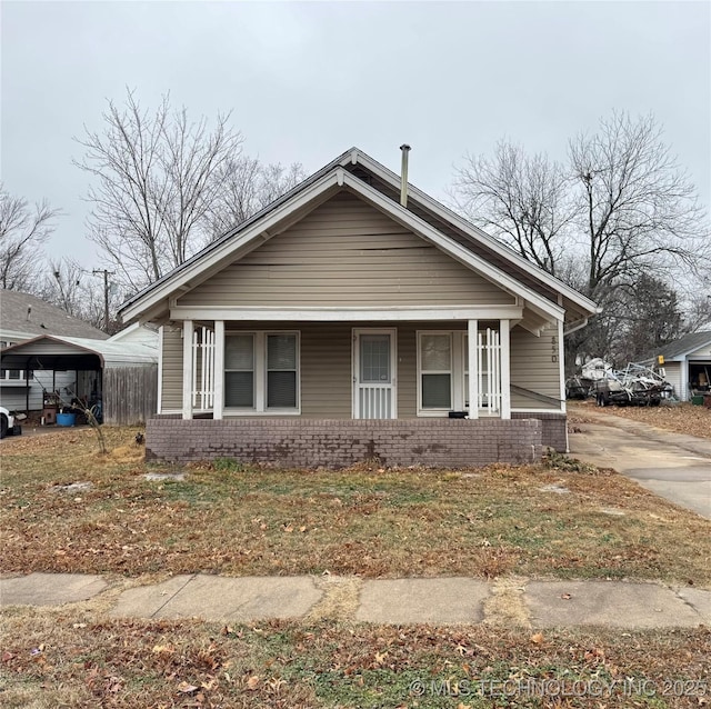 bungalow featuring a carport and a porch