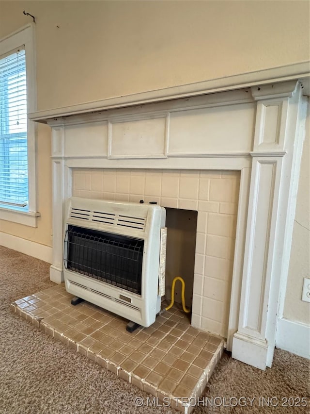 room details with a brick fireplace, carpet floors, and heating unit