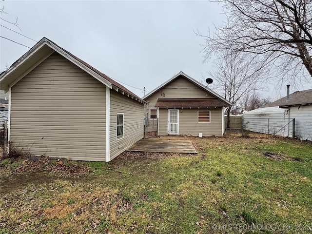 rear view of property with a lawn