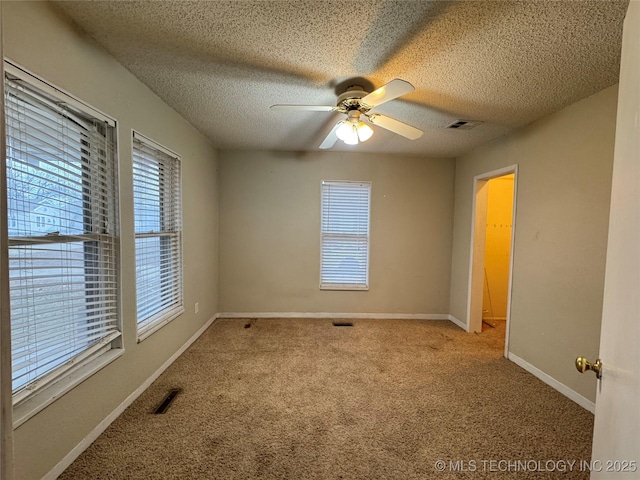 unfurnished room with light carpet, a textured ceiling, and ceiling fan