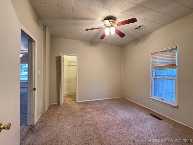 carpeted empty room featuring ceiling fan