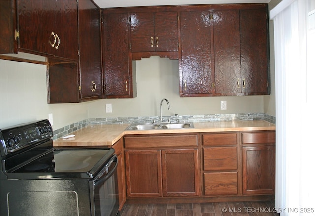 kitchen featuring stainless steel counters, sink, dark hardwood / wood-style floors, and black range with electric cooktop