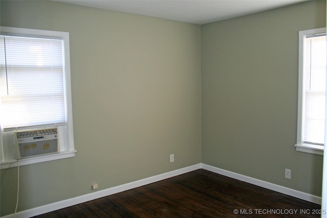 unfurnished room featuring dark hardwood / wood-style floors, a wealth of natural light, and cooling unit