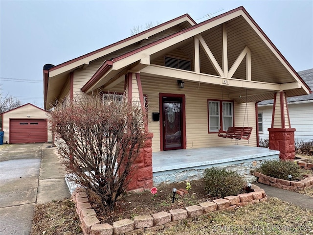 view of front of house with a porch, a garage, and an outdoor structure