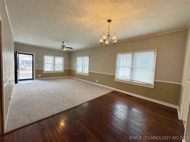 empty room with wood-type flooring, ornamental molding, and ceiling fan with notable chandelier