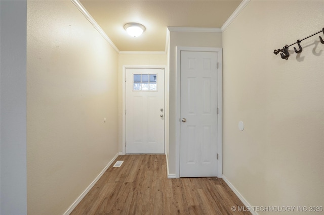 entryway featuring crown molding and light hardwood / wood-style floors