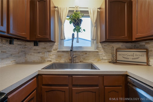 kitchen with tasteful backsplash, dishwasher, and sink