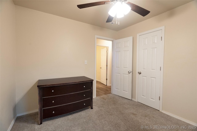 unfurnished bedroom with light carpet and ceiling fan