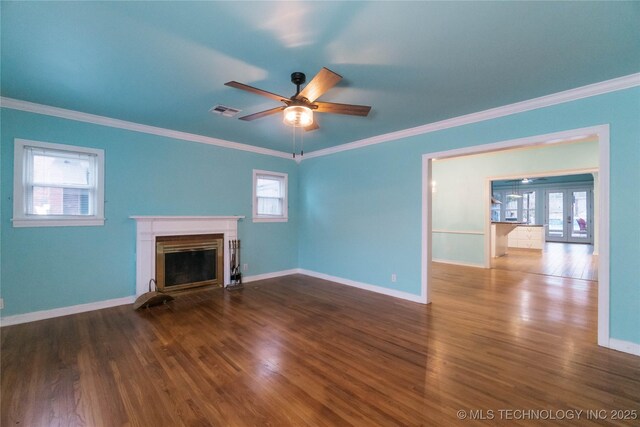 unfurnished living room featuring ornamental molding, ceiling fan, dark hardwood / wood-style flooring, and french doors