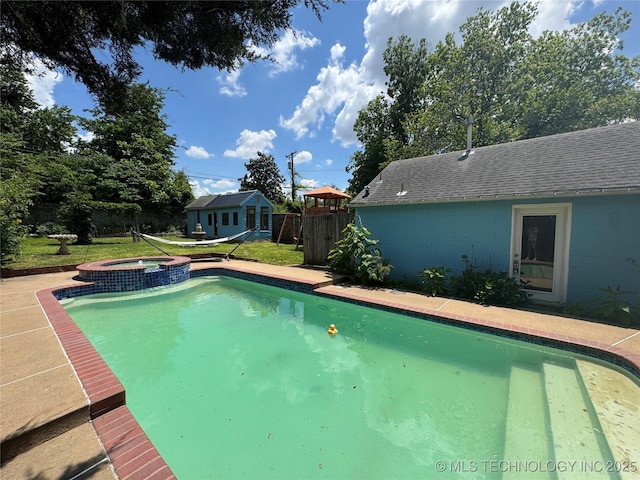 view of swimming pool featuring an outdoor structure and a pool with connected hot tub