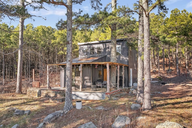 rear view of property with a porch