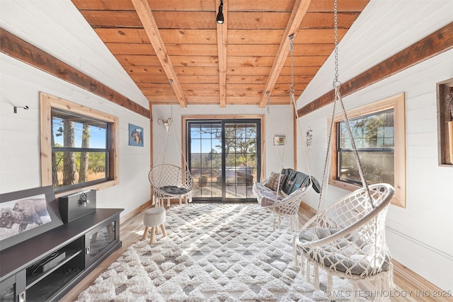 sitting room featuring plenty of natural light, vaulted ceiling with beams, and wood ceiling