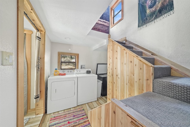 laundry room featuring light hardwood / wood-style floors and washer and dryer