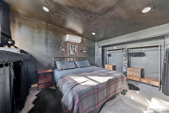 carpeted bedroom featuring a wall unit AC