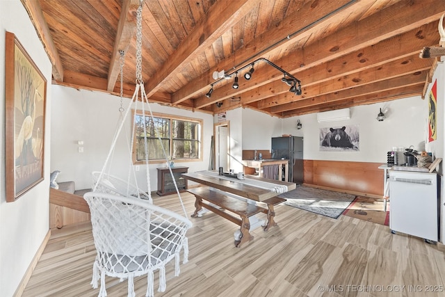 home office with beam ceiling, light hardwood / wood-style flooring, wooden ceiling, and an AC wall unit