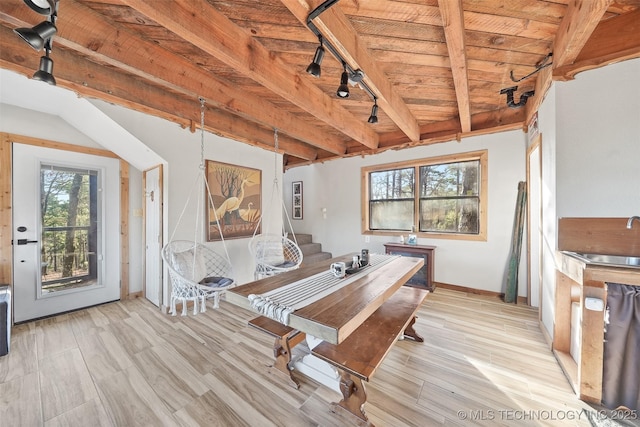 unfurnished dining area featuring wood ceiling, a wealth of natural light, beamed ceiling, and light wood-type flooring