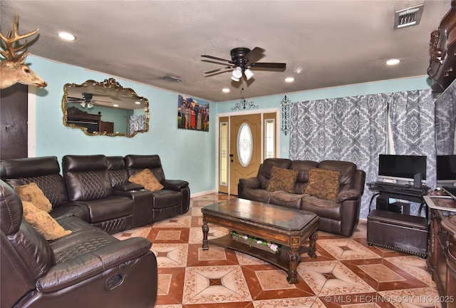 tiled living room featuring a textured ceiling and ceiling fan