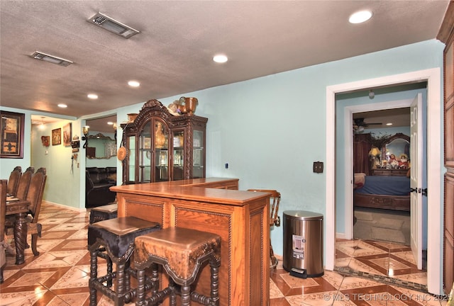 bar with a textured ceiling