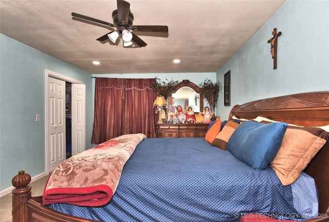 carpeted bedroom with ceiling fan, a closet, and a textured ceiling