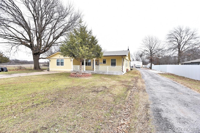 view of front of home featuring covered porch and a front yard