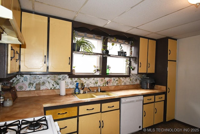 kitchen with white appliances, sink, and a drop ceiling