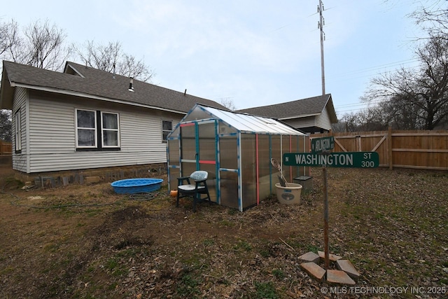 rear view of property with an outbuilding