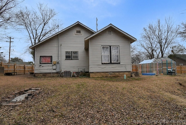 back of house featuring an outdoor structure and central air condition unit