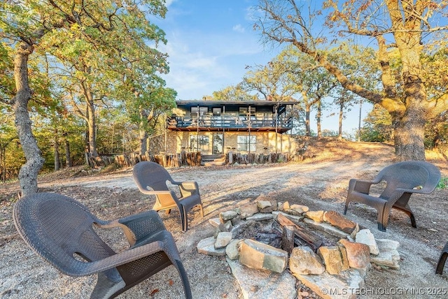 view of patio / terrace featuring a deck and a fire pit