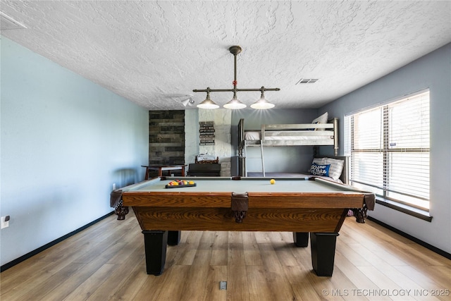 game room with rail lighting, billiards, a textured ceiling, and light hardwood / wood-style flooring