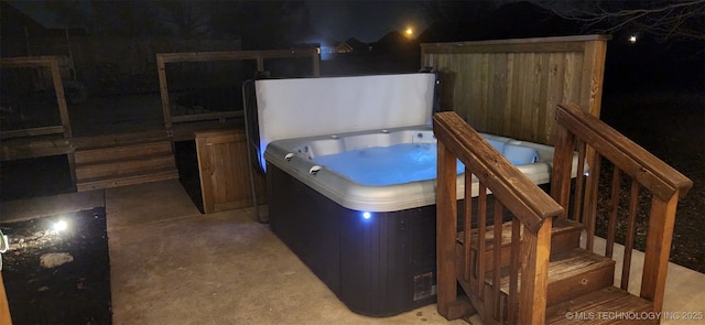 wooden deck with a hot tub